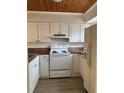 Classic-style kitchen features white cabinetry, laminate countertops, and modern appliances at 334 Scottsdale Sq # 334, Winter Park, FL 32792