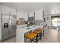 Updated kitchen featuring white cabinets and breakfast bar at 3509 S Atlantic Ave # 208, New Smyrna Beach, FL 32169