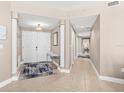 Inviting foyer with tile flooring, neutral walls, decor, and a double door entrance at 3737 S Atlantic Ave # 502, Daytona Beach, FL 32118
