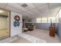 Finished basement with a couch, TV, and open space at 469 S Halifax Dr, Ormond Beach, FL 32176