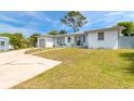 House exterior showcasing a single-story home with a large yard at 469 S Halifax Dr, Ormond Beach, FL 32176