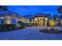 Elegant home with a paver driveway and landscaped grounds at 5 Cross Creek Way, Ormond Beach, FL 32174