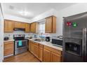 Cozy kitchen with stainless steel appliances and light oak cabinets at 501 W Lisbon Pkwy, Deland, FL 32720