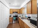 Kitchen with wood cabinets and stainless steel appliances at 501 W Lisbon Pkwy, Deland, FL 32720