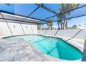 Inviting in-ground pool with a screened enclosure and a spacious deck for outdoor lounging at 681 N Halifax Dr, Ormond Beach, FL 32176