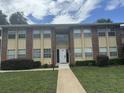 Brick building exterior with landscaping and walkway at 701 Perkins St # 100, Leesburg, FL 34748