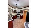 Spacious kitchen with dark wood cabinets and granite countertops at 8101 Via Bonita St, Sanford, FL 32771
