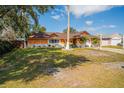 Single Gathering home with an orange stucco and white brick exterior and a well maintained front lawn at 878 Abbott Ave, Deltona, FL 32725