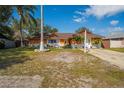 Single Gathering home with an orange stucco and white brick exterior and a well maintained front lawn at 878 Abbott Ave, Deltona, FL 32725