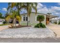 Single-wide manufactured home with palm trees and gravel landscaping at 9 Florence Blvd, Debary, FL 32713