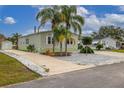 Single-wide manufactured home with spacious driveway and landscaping at 9 Florence Blvd, Debary, FL 32713