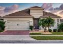 Exterior view of a single-Gathering house with a gray facade and a brick driveway at 962 Compass Landing Dr, Orange City, FL 32763