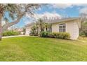 House exterior showcasing landscaping and a partial view of the driveway at 123 Ponce Terrace Cir, Ponce Inlet, FL 32127