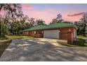 Attached brick garage with white door and driveway at 1908 S Farm Rd, Deland, FL 32720