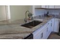 Modern kitchen features granite countertops and stainless steel appliances at 222 Oak Branch Dr, Edgewater, FL 32141