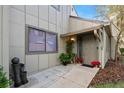 Inviting townhouse entryway with potted plants and decorative accents at 235 Pine Cone Trl, Ormond Beach, FL 32174