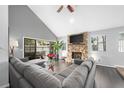 Spacious living room with stone fireplace, hardwood floors, and large sectional sofa at 235 Pine Cone Trl, Ormond Beach, FL 32174