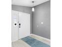 Bright entryway with light gray walls and a teal rug at 2888 Berkshire Woods Ter, Deltona, FL 32725