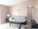 Bright living room with gray couch and tile floors at 3019 N Covington Dr, Deltona, FL 32738