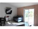 Living room with blue couch and sliding glass doors at 3019 N Covington Dr, Deltona, FL 32738