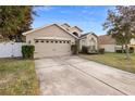 Two-car garage and a well-maintained lawn at 3125 Wood Rose Way, Deltona, FL 32725