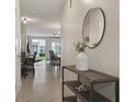 Bright and airy entryway with tile flooring and a modern console table at 37 Bella Lago Cir, Port Orange, FL 32129