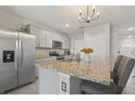 Modern kitchen with granite island and stainless steel appliances at 37 Bella Lago Cir, Port Orange, FL 32129