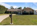 House exterior with landscaping and driveway at 373 Blythville Ave, Deltona, FL 32725