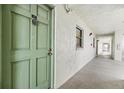 Building hallway with green door to condo unit at 3800 S Atlantic Ave # 5040, Daytona Beach, FL 32118