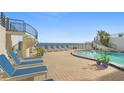 Ocean view pool and deck area with lounge chairs at 395 S Atlantic Ave # 301, Ormond Beach, FL 32176