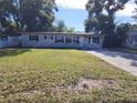 Front view of a single-story house with a lawn at 5108 Cassatt Ave, Orlando, FL 32808