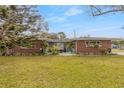 Charming single-story home featuring manicured lawn and well-maintained landscaping at 559 Eagle Dr, Daytona Beach, FL 32117