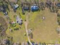 Bird's-eye view showcasing home, pool, and surrounding land at 601 Rasley Rd, New Smyrna Beach, FL 32168