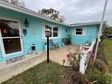 Inviting front porch with seating area and colorful flowers at 744 Baywood Ln, South Daytona, FL 32119