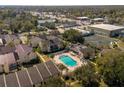 Aerial view of condo complex with pool and tennis court at 100 E Kentucky Ave # K106, Deland, FL 32724