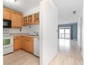 Bright kitchen with light wood cabinets and appliances at 100 E Kentucky Ave # K106, Deland, FL 32724
