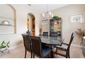 Formal dining room featuring a dark wood table and glass-top at 1105 Gardenshire Ln, Deland, FL 32724
