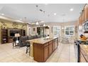 Spacious kitchen boasts an island, granite countertops, and ample cabinetry at 1105 Gardenshire Ln, Deland, FL 32724