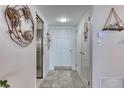 Bright entryway with tiled floor, white door, and coastal-themed wall art at 1224 S Peninsula Dr # 511, Daytona Beach, FL 32118