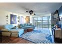 Living room boasts hardwood floors, blue sofas, and stunning river views at 1224 S Peninsula Dr # 511, Daytona Beach, FL 32118