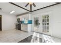 Bright kitchen with white cabinets, stainless steel appliances, and turquoise backsplash opens to outdoor patio at 1240 W Voorhis Ave, Deland, FL 32720