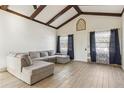 Inviting living room with high ceilings, exposed beams, comfortable seating, and plenty of natural light at 1240 W Voorhis Ave, Deland, FL 32720