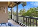 Inviting screened balcony with calming nature views and comfortable seating for relaxation at 1401 S Palmetto Ave # 614, Daytona Beach, FL 32114