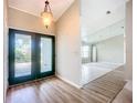 Bright entryway with dark green double doors and wood-look floors at 1412 Oak Forest Dr, Ormond Beach, FL 32174