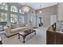 Spacious living room with neutral colors, hardwood floors, and a large window at 1450 Alden St, Deland, FL 32720