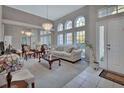 Bright living room with hardwood floors, large windows, and comfortable furniture at 1450 Alden St, Deland, FL 32720