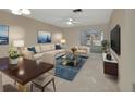Bright living room with a sofa, chairs, and dining table at 2 Villa Villar Ct # 02, Deland, FL 32724
