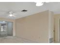Living room with sliding doors leading to sunroom at 2 Villa Villar Ct # 02, Deland, FL 32724