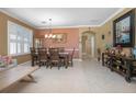 Spacious dining room with a large wooden table and neutral color scheme at 204 Wellington Woods Ave, Deland, FL 32724