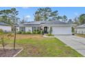 House exterior showcasing a well-maintained lawn and solar panels at 216 Hickory Ave, Orange City, FL 32763